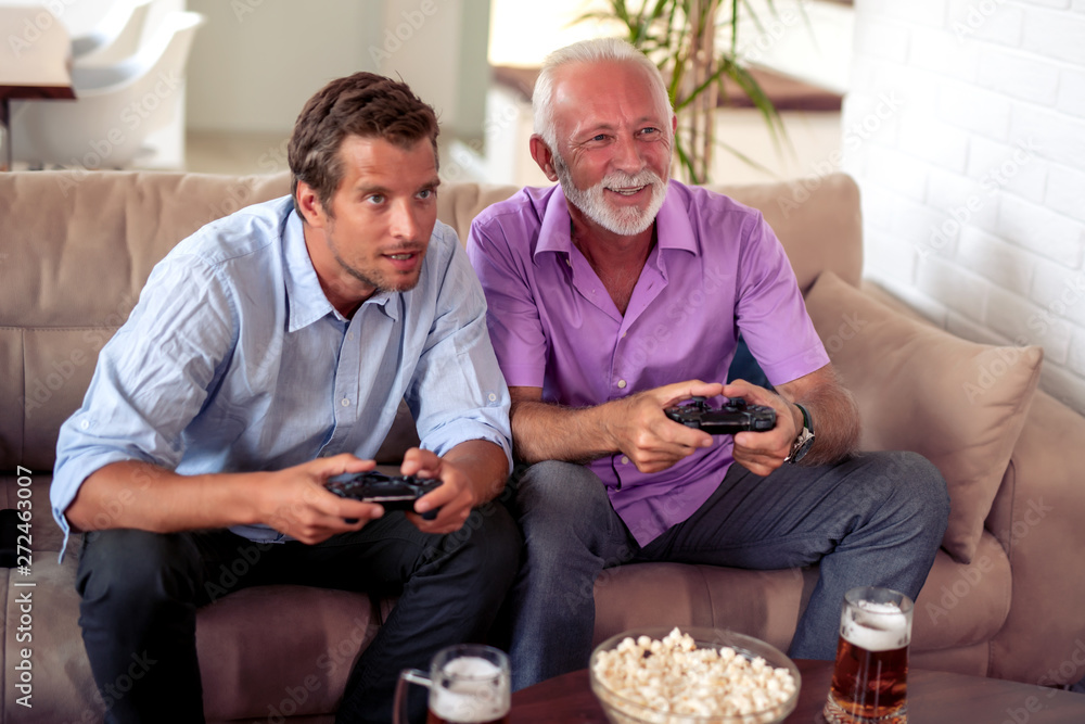 Men playing video game at home Men playing video game at home