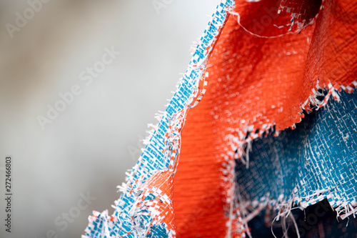 weathered and torn tarpaulin because of sun expose photo background