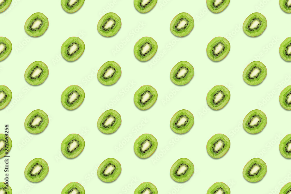 Kiwi slices seamless pattern on pastel green background. Minimal summer concept. Flat lay, trendy juicy color. Kiwi slices seamless pattern on pastel green background. Minimal summer concept. Flat lay, trendy juicy color.