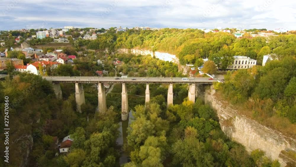 Aerial, top view from Drone. The bridge between the rocks in Kamenetz Podolsky. View of the road from the top. Autumn time. Aerial, top view from Drone. The bridge between the rocks in Kamenetz Podolsky. View of the road from the top. Autumn time.