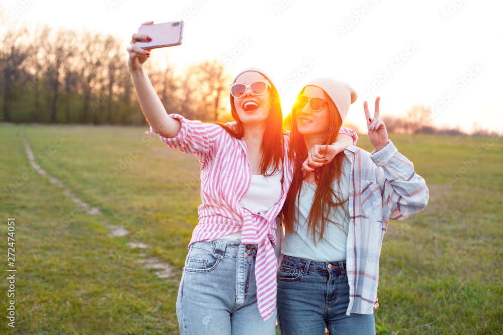 Two best friends shoot selfie with sunset background Stock Photo | Adobe  Stock