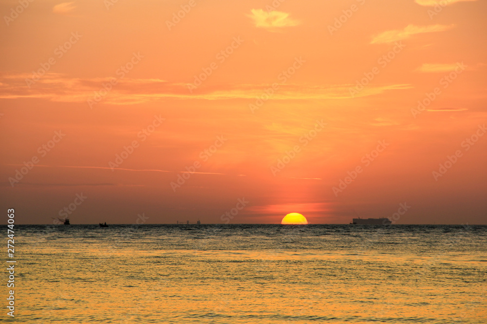 Beautiful sunset above the sea. there are Big boat and fishing boat. Landscape with boat in the sea at twilight. Beautiful sunset above the sea. there are Big boat and fishing boat. Landscape with boat in the sea at twilight.