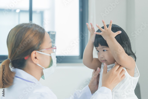 Asian doctor using a stethoscope to check his breathing and heart of a lovely girl, check the health of children,Thailand people