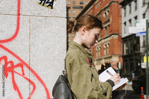 Young woman writing in notebook photo