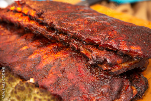 Several slabs of BBQ ribs on a wooden board