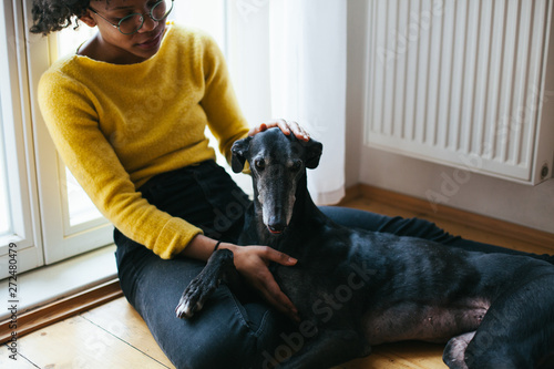 Woman spending time with her dog indoor