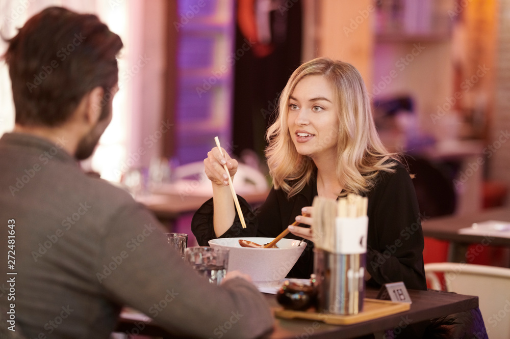 Couple enjoying meal and chatting in cafe Couple enjoying meal and chatting in cafe