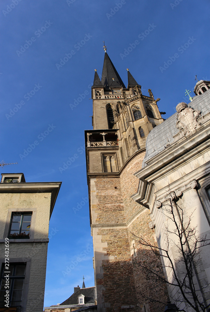 Side view from the bottom and the details of Aachen Cathedral. Facade of Aix-la-Chapelle, Roman Catholic church in Aachen, western Germany.