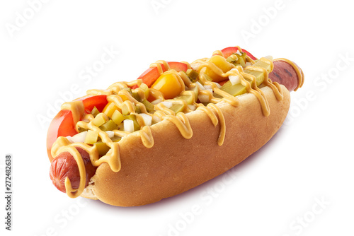 Hot dog with pickles and tomatoes on white photo