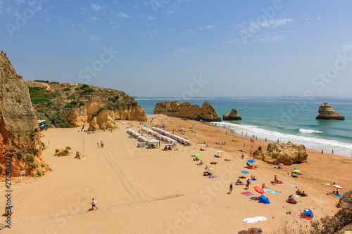 Scenic landscape view of golden cliffs and emerald water in Camilo beach (Praia do Camilo) in Lagos, Algarve, Portugal
