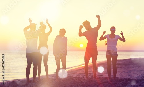 Group of happy friends having fun together on the beach