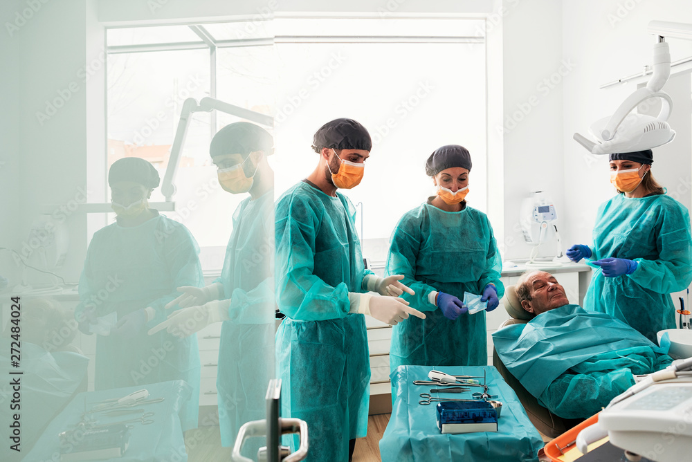 Team of surgeons during a dental surgery with a patient. Team of surgeons during a dental surgery with a patient.