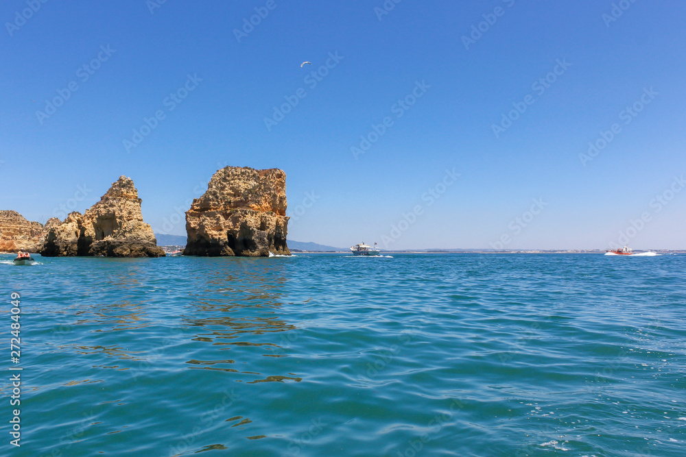 Panoramic landscape view of golden cliffs and emerald water in Ponta da Piedade, Lagos, Algarve, Portugal Panoramic landscape view of golden cliffs and emerald water in Ponta da Piedade, Lagos, Algarve, Portugal
