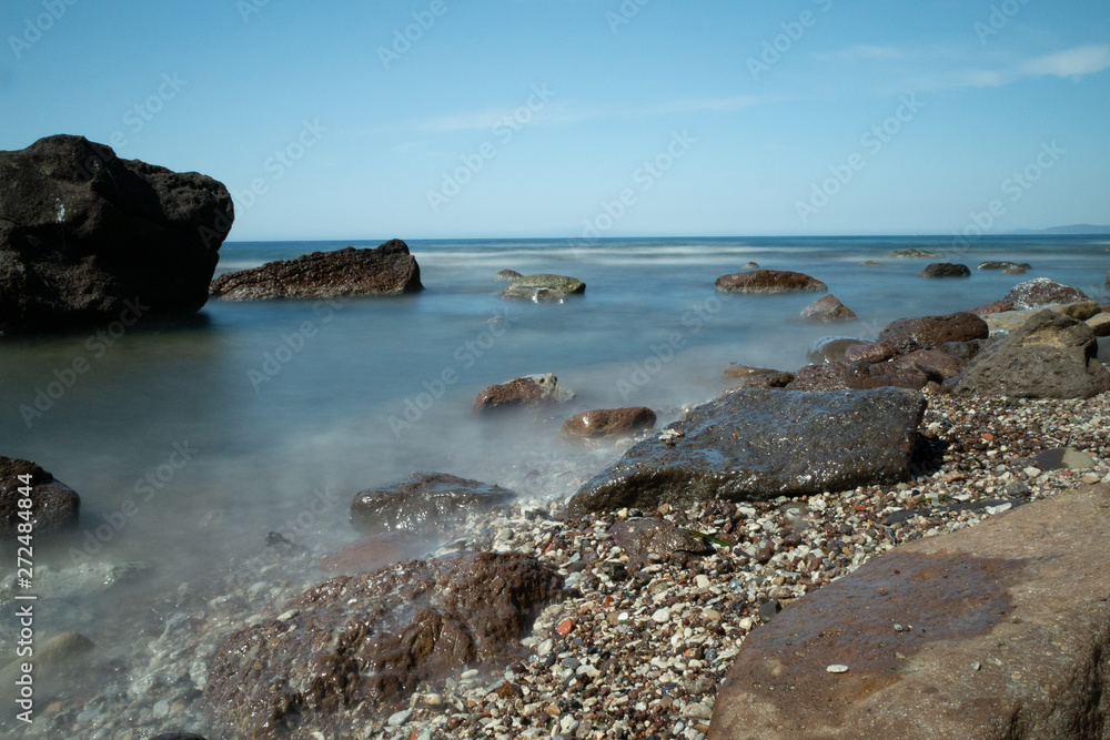 sea with beach and stones in the sea