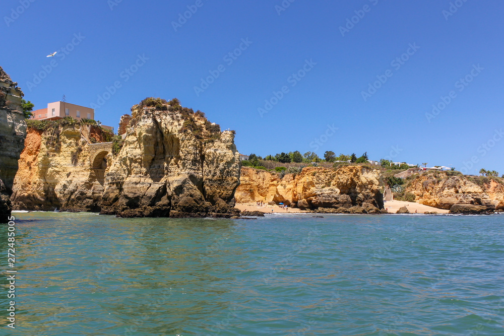 Panoramic landscape view of golden cliffs and emerald water in Ponta da Piedade, Lagos, Algarve, Portugal Panoramic landscape view of golden cliffs and emerald water in Ponta da Piedade, Lagos, Algarve, Portugal