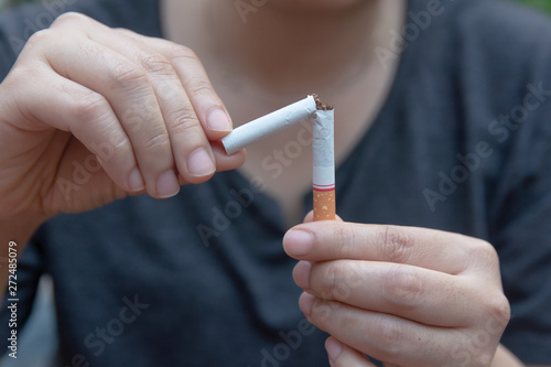 Stop cigarette, woman hands breaking the cigarette with clipping path