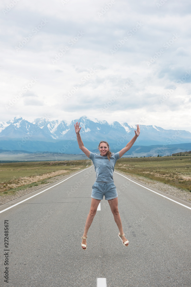 Woman sitting on the beauty road in mountain Woman sitting on the beauty road in mountain