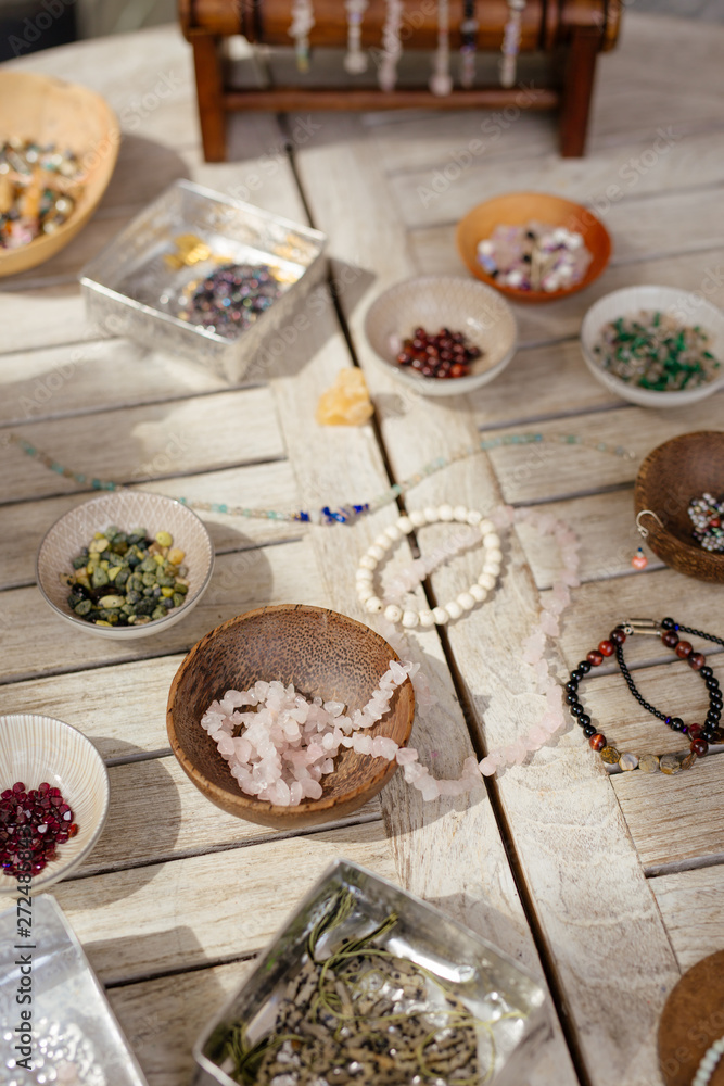 a lot of different beads on a rustic wooden table. a lot of different beads on a rustic wooden table.