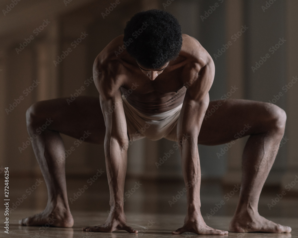 Muscular man stretching in the hall Muscular man stretching in the hall