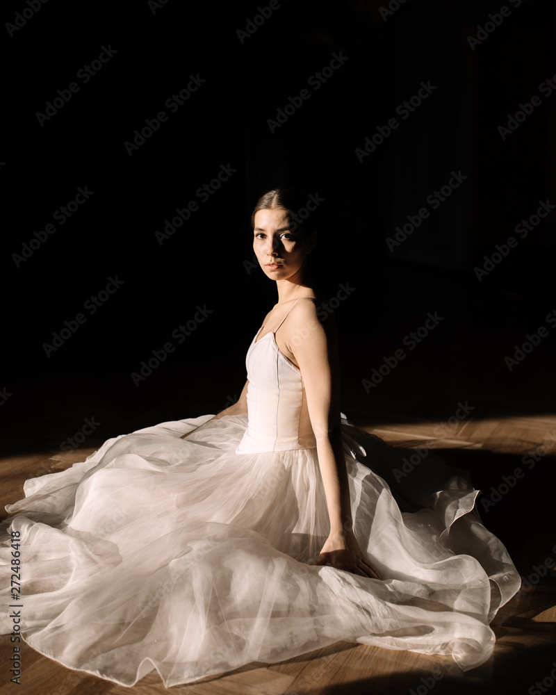 Portrait of ballet dancer sitting on floor Portrait of ballet dancer sitting on floor