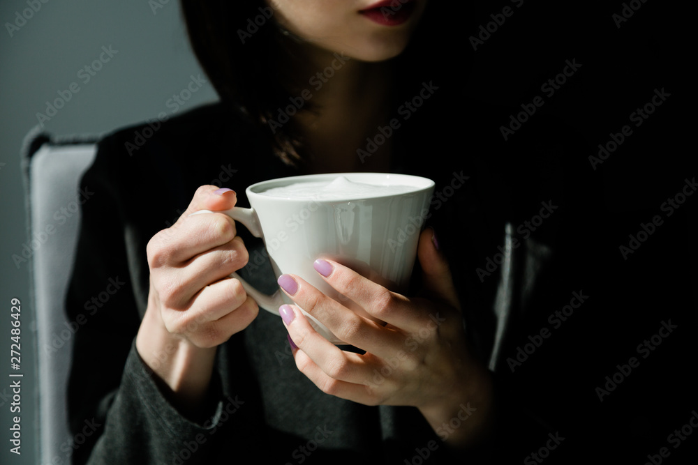 Midsection of woman holding coffee up Midsection of woman holding coffee up