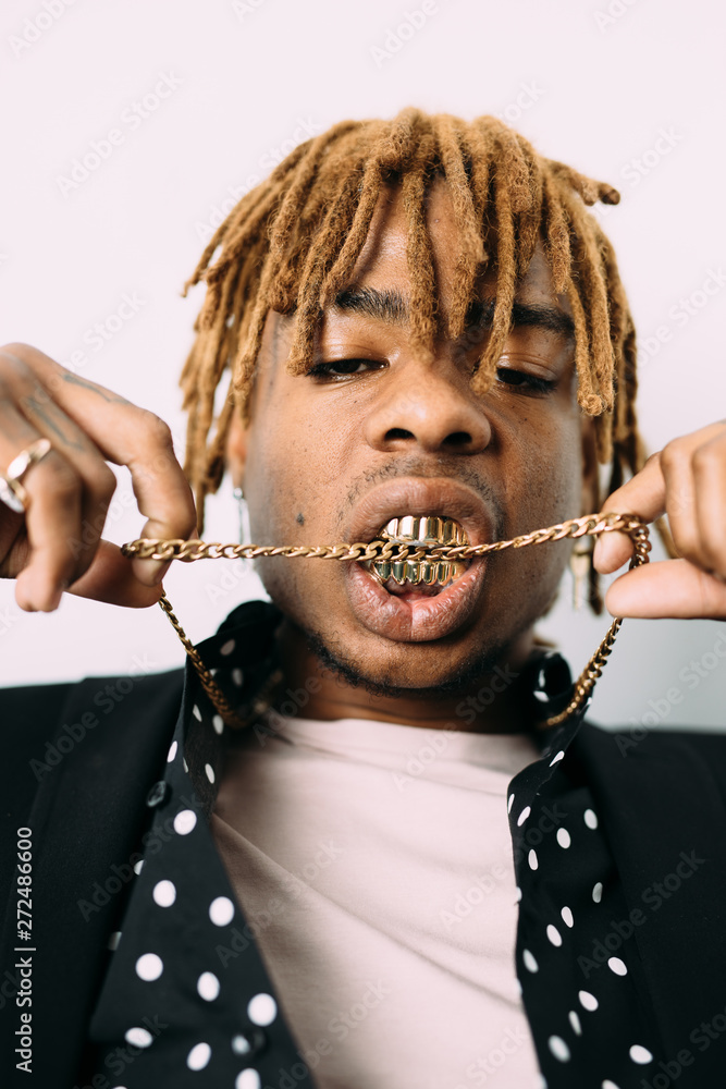 Black man with golden teeth biting chain Stock Photo | Adobe Stock