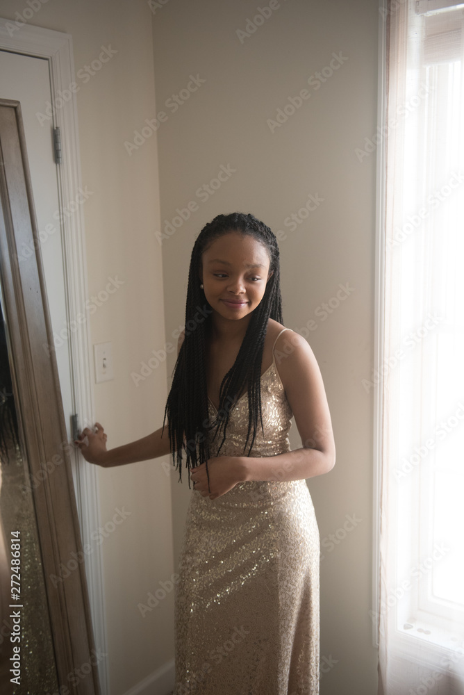 African American teen standing in her prom dress African American teen standing in her prom dress