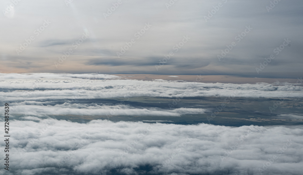 Clouds seen from an airplane, blue sunshine, soil background nature landscape Clouds seen from an airplane, blue sunshine, soil background nature landscape