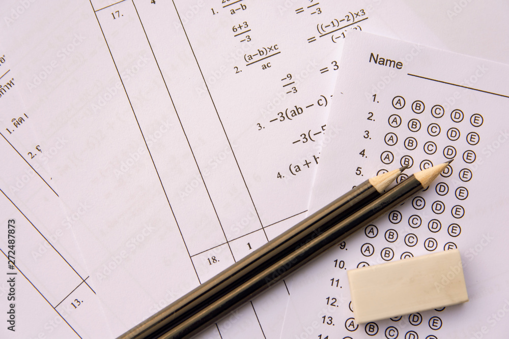 Pencil and eraser on answer sheets or Standardized test form with answers bubbled. multiple choice answer sheet . Pencil and eraser on answer sheets or Standardized test form with answers bubbled. multiple choice answer sheet .