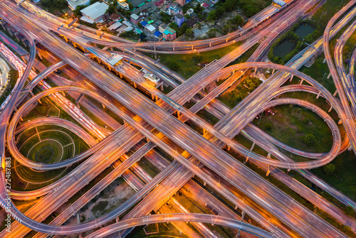 Aerial view of highway at rush hour at night time with car trail and traffic. view from drone
