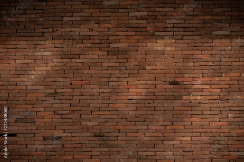 dimly lit old brick wall.