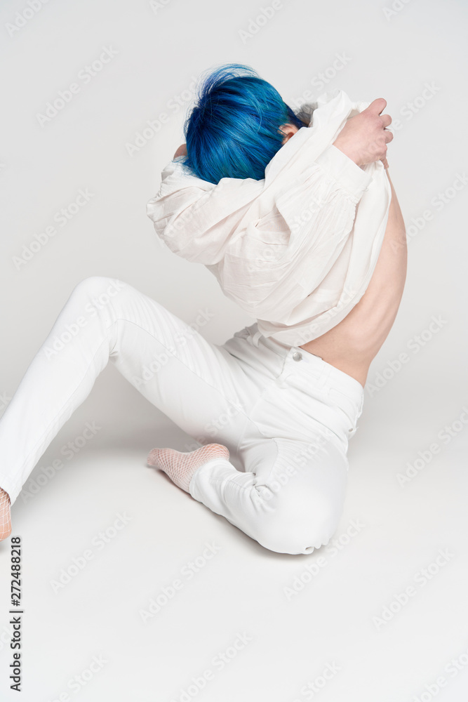 Blue haired young attractive woman undressing Blue haired young attractive woman undressing
