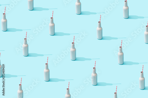 Trendy sunlight Summer pattern made with white bottle on bright light blue background. Minimal summer concept.