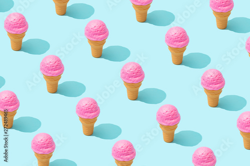 Obraz na plátne Trendy sunlight Summer pattern made with pink strawberry ice cream on bright light blue background