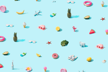 Trendy sunlight Summer pattern made with various summer things on bright light blue background. Minimal summer vacation concept.