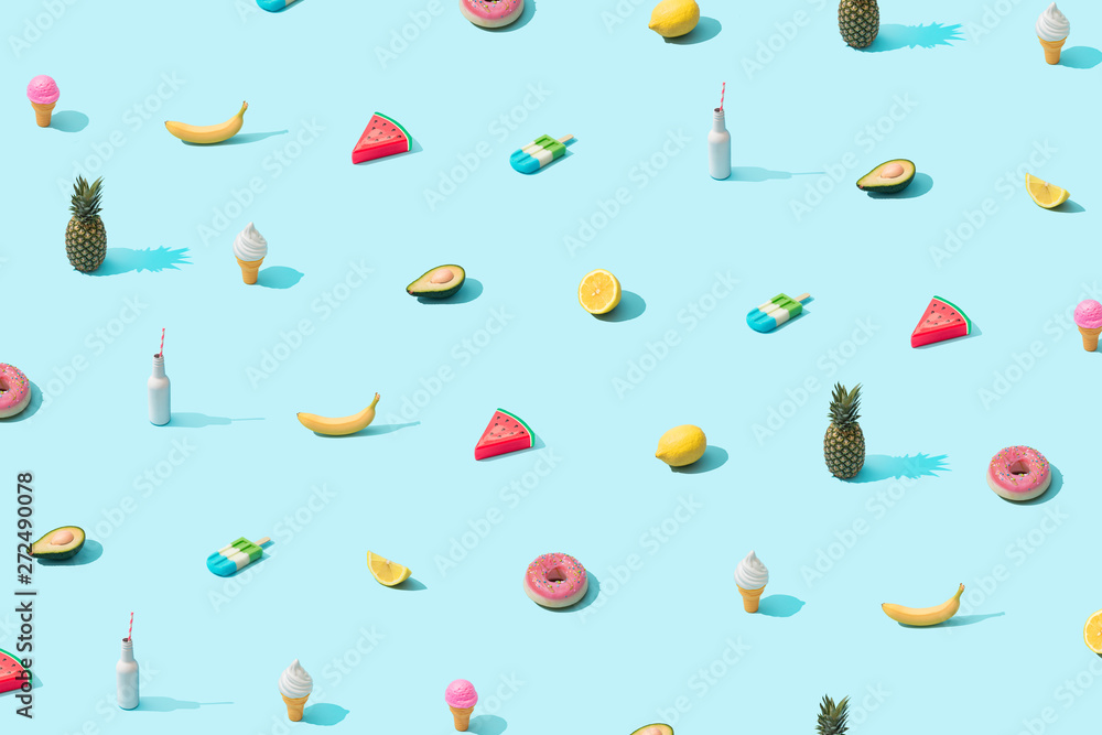 Trendy sunlight Summer pattern made with various summer food on bright light blue background. Minimal summer food concept.