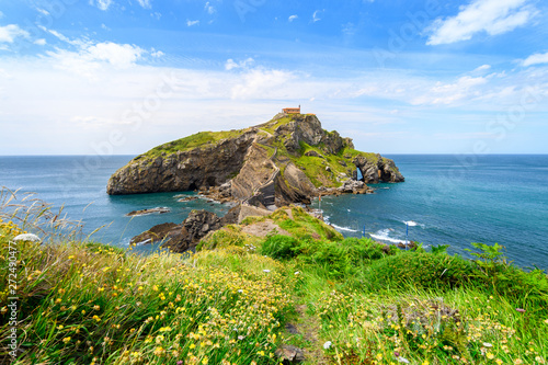 sunny day at gaztelugatxe island, located at basque country coastline photo