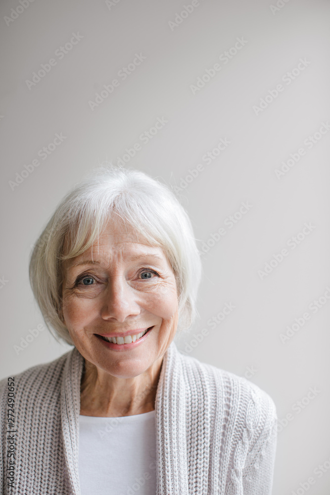 Studio portrait of senior woman on simple grey background Studio portrait of senior woman on simple grey background