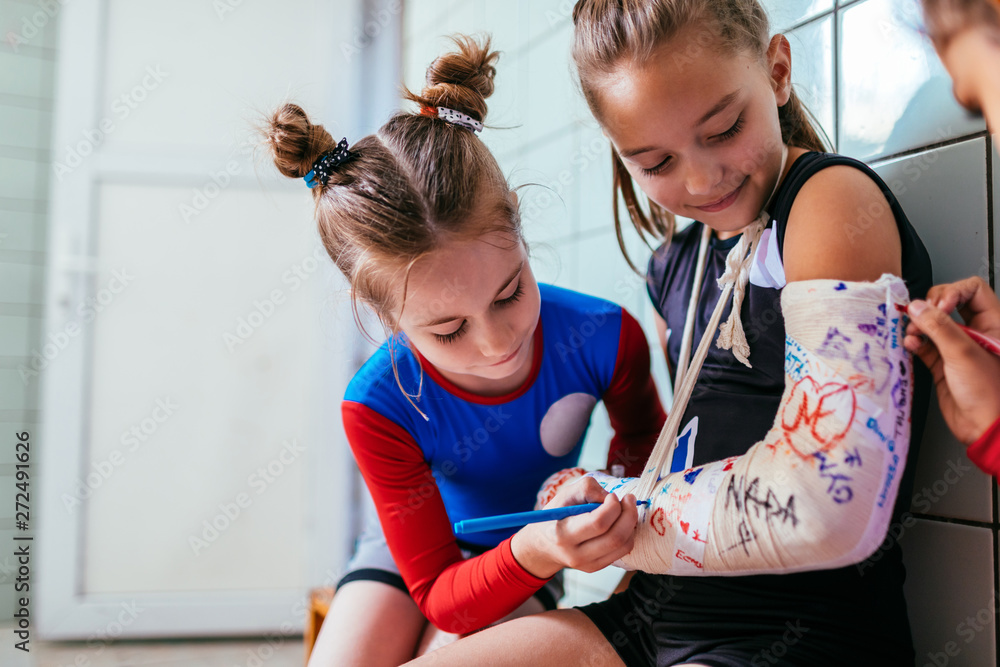 Girls sign plaster cast on a broken arm ภาพถ่ายสต็อก Adobe Stock