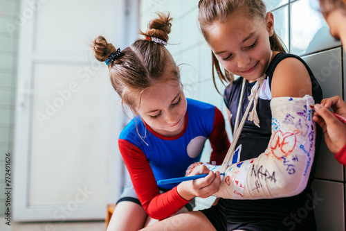 Girls sign plaster cast on a broken arm