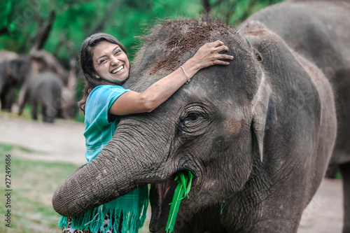 Sticker Girl having fun with elephants at Patara Elephant Farm, Chiang Mai, Thailand
