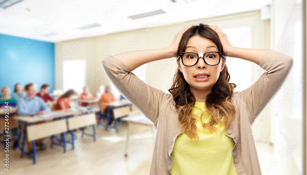 school, education and stress concept - asian woman or student in glasses fixed by tape holding to her head over classroom background school, education and stress concept - asian woman or student in glasses fixed by tape holding to her head over classroom background
