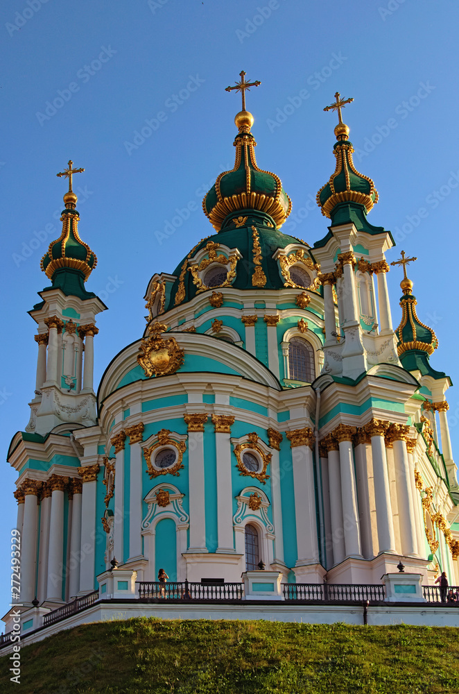 Beautiful landscape photo of charming ancient Saint Andrew Church in baroque style. Vibrant blue sky at the background. Kyiv, Ukraine