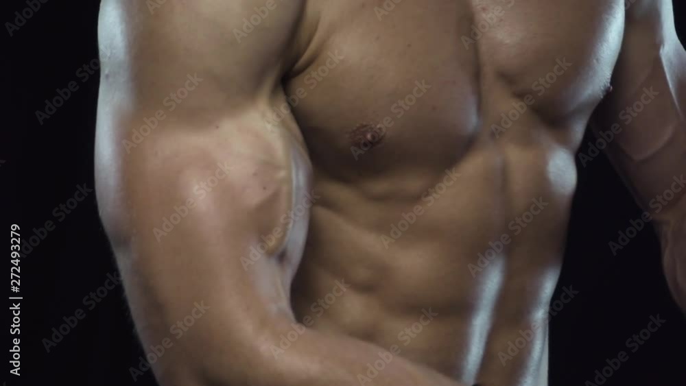 Young fit guy shows biceps, close up, slow motion, dolly zoom Young fit guy shows biceps, close up, slow motion, dolly zoom