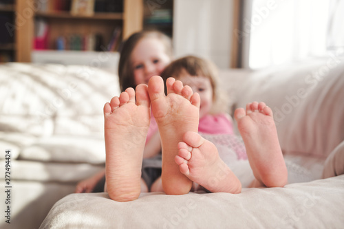 Siblings having fun and showing their feet photo