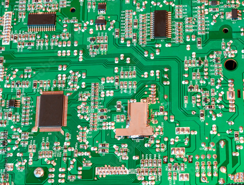 Green electronic board with microcircuits close up
