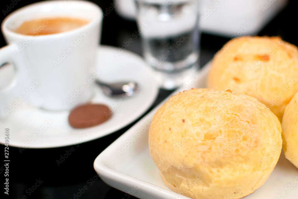 Traditional Brazilian snack cheese bread in a bistro table with a cup of coffee Traditional Brazilian snack cheese bread in a bistro table with a cup of coffee