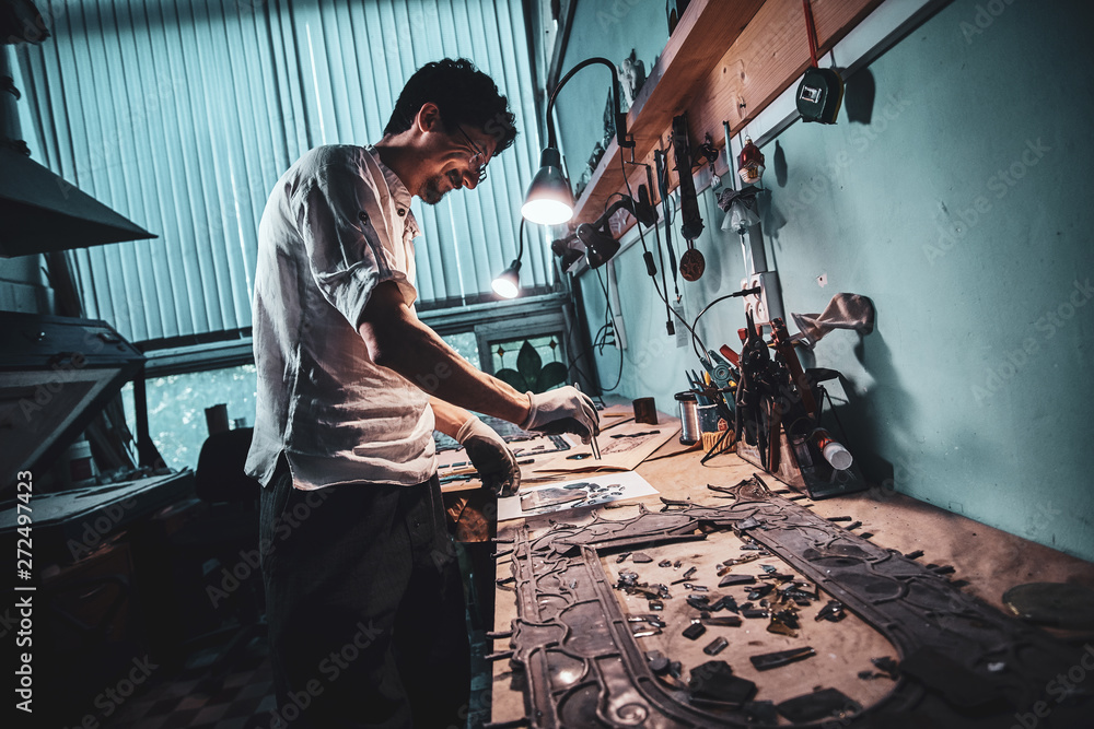 Diligent craftman is restoring ancient broken stained glass at his own workshop. Diligent craftman is restoring ancient broken stained glass at his own workshop.
