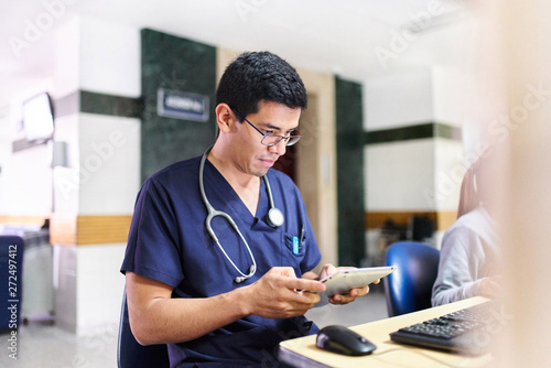 Young male doctor with a tablet