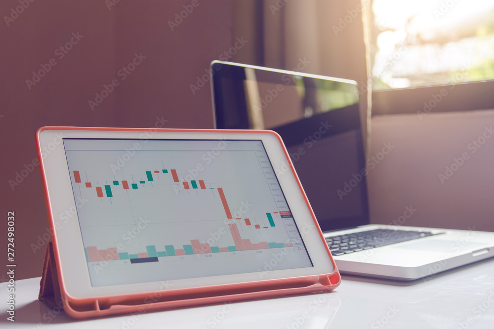Stock trading forex on tablet on a white Table Stock trading forex on tablet on a white Table